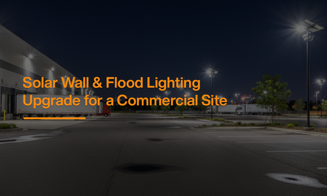 Commercial site illuminated at night with solar wall pack lights and solar flood lighting systems installed across the parking and building perimeter.