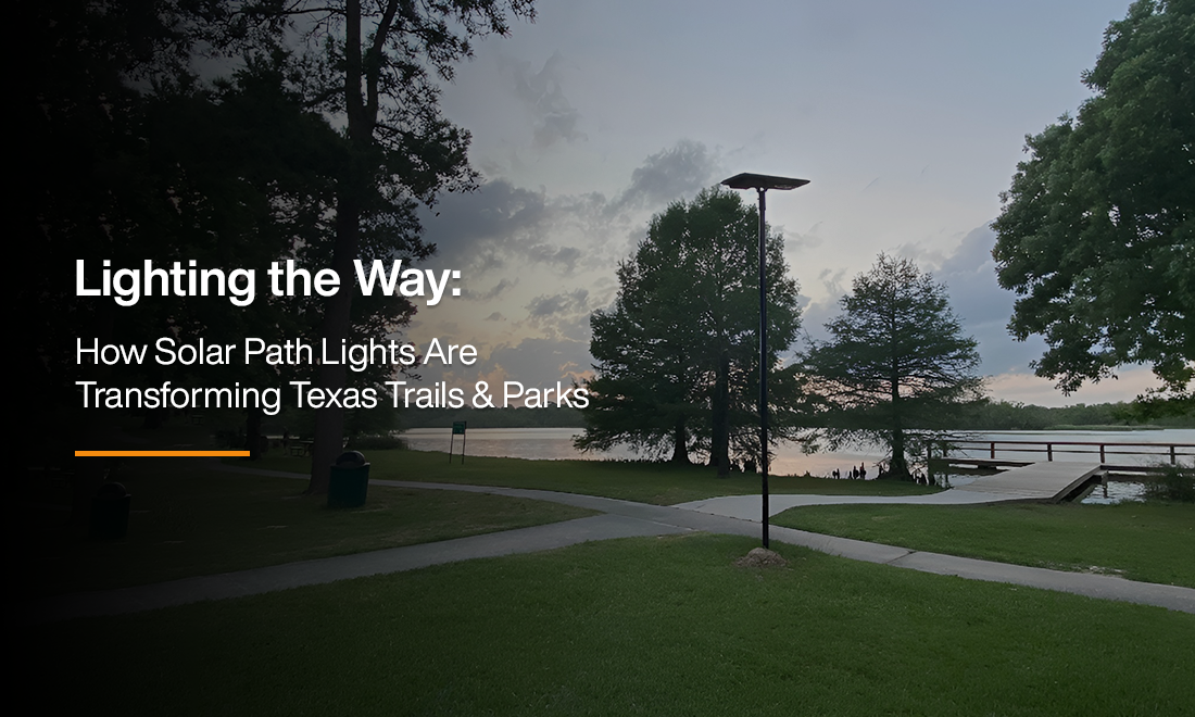 Solar path light illuminating a walking trail near a lake in Texas park at sunset, showcasing sustainable outdoor lighting for community safety.