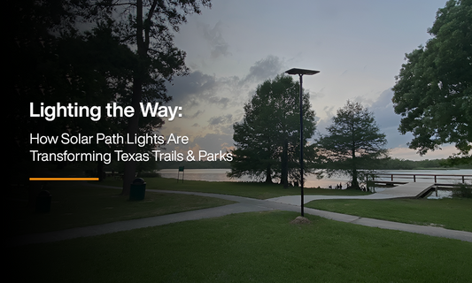 Solar path light illuminating a walking trail near a lake in Texas park at sunset, showcasing sustainable outdoor lighting for community safety.